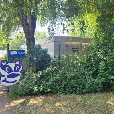 Image of nursery gates and fence with logo for wind in the willows